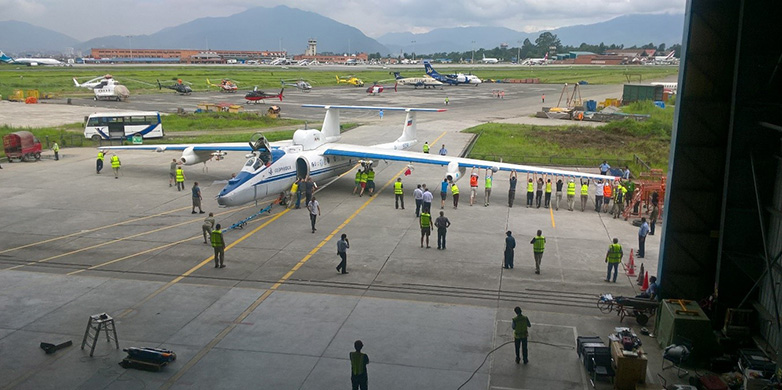 Enlarged view: Maneuvering the aircraft out of Buddha Air Hangar at Kathmandu Airport (Photo: Thomas Peter).